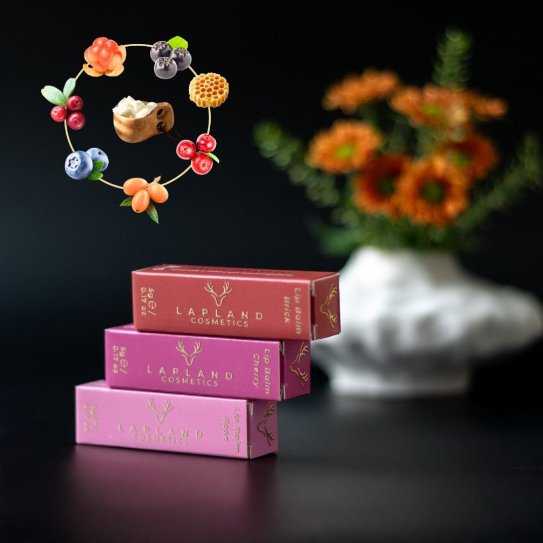 Three Lapland Cosmetics tinted lip balms in Rose, Cherry and Brick shades, with reindeer tallow, beeswax and Arctic berry ingredients shown above the product boxes.
